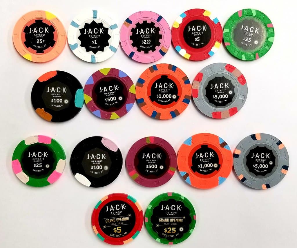 A sample set of JACK Detroit casino chips, each denomination with its own colors, edge spots, and center inlay