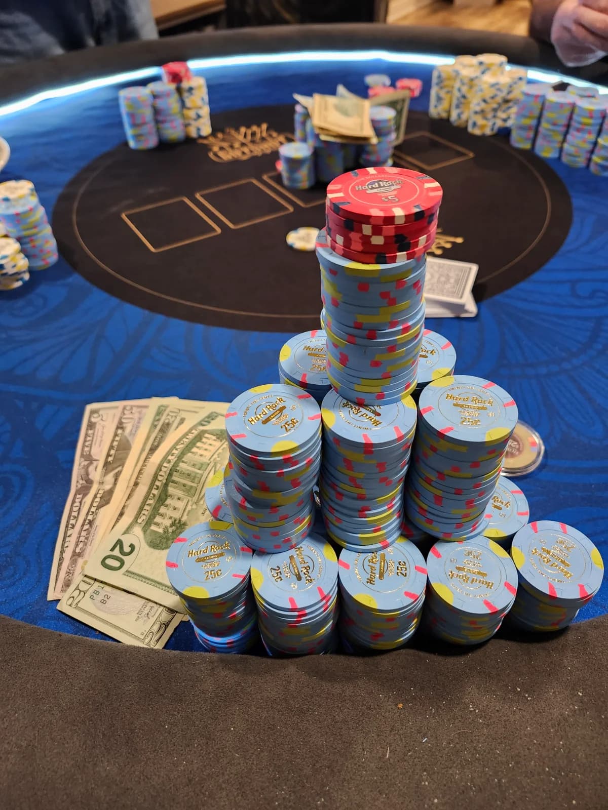 A poker table covered end to end with tall stacks of chips